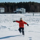 Child in winter clothes running through snow-covered field Child in winter clothes running through snow-covered field - PhotoDune Item for Sale