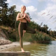 Woman balancing in tree pose on wooden platform above water Woman balancing in tree pose on wooden platform above water - PhotoDune Item for Sale