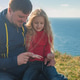dad plays with his daughter in nature on a clear day against the backdrop of mountains and the sea dad plays with his daughter in nature on a clear day against the backdrop of mountains and the sea - PhotoDune Item for Sale
