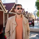 Man wearing sunglasses standing in front of decorated house Man wearing sunglasses standing in front of decorated house - PhotoDune Item for Sale