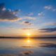 Serene sunset over calm lake with vibrant colors reflecting on water. Serene sunset over calm lake with vibrant colors reflecting on water. - PhotoDune Item for Sale