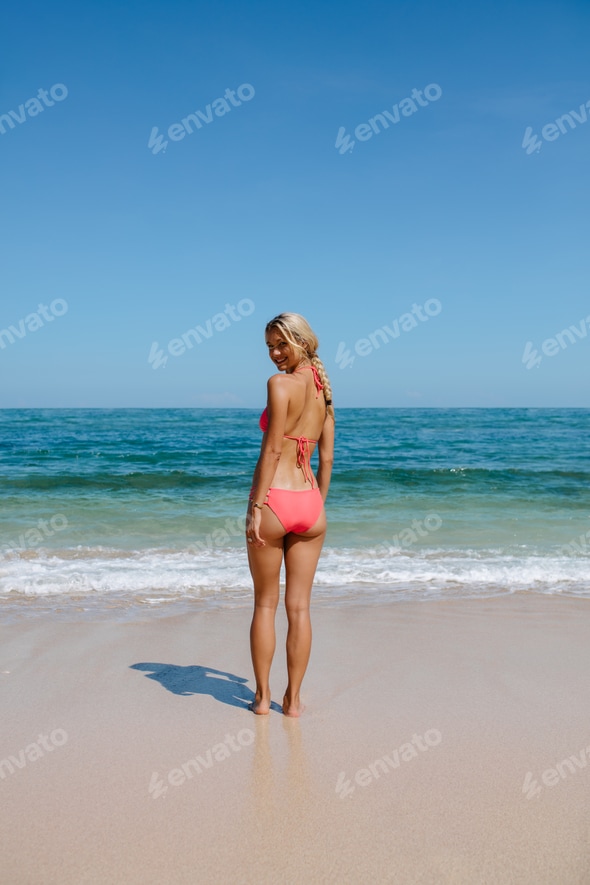 Beautiful woman in bikini at the beach Stock Photo by jacoblund