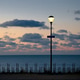 lantarn light with ocean in the back and sunset clouds in the sky lantarn light with ocean in the back and sunset clouds in the sky - PhotoDune Item for Sale