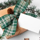 Christmas rectangle gift tag mockup with present box on white wooden background Christmas rectangle gift tag mockup with present box on white wooden background - PhotoDune Item for Sale