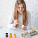 Young woman coloring eggs for Easter at home Young woman coloring eggs for Easter at home - PhotoDune Item for Sale