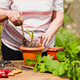 woman transplanting green plant outdoors woman transplanting green plant outdoors - PhotoDune Item for Sale