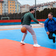 Two men play basketball on an outdoor court in a city setting during a cloudy day Two men play basketball on an outdoor court in a city setting during a cloudy day - PhotoDune Item for Sale