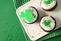 Holiday homemade cupcakes for Happy St Patricks Day on green background. Holiday homemade cupcakes for Happy St Patricks Day on green background. - PhotoDune Item for Sale
