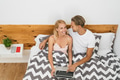 Happy couple lying on bed while using laptop computer - Happy people having funny bed time Happy couple lying on bed while using laptop computer - Happy people having funny bed time - PhotoDune Item for Sale