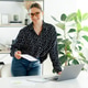 Confident positive businesswoman with glasses, standing near a work desk while holding a document Confident positive businesswoman with glasses, standing near a work desk while holding a document - PhotoDune Item for Sale