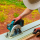 Worker uses power saw to cut vinyl siding for construction project Worker uses power saw to cut vinyl siding for construction project - PhotoDune Item for Sale