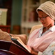 Young girl sitting on the sofa reading a book at night just before bed Young girl sitting on the sofa reading a book at night just before bed - PhotoDune Item for Sale