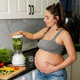 Young pregnant woman drinking healthy green smoothie at home. Young pregnant woman drinking healthy green smoothie at home. - PhotoDune Item for Sale