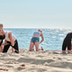 Young women practicing group yoga stretches on Sunny Baltic Sea beach Young women practicing group yoga stretches on Sunny Baltic Sea beach - PhotoDune Item for Sale