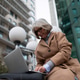 Senior woman working on laptop outside an urban building during a sunny day while dressed in a Senior woman working on laptop outside an urban building during a sunny day while dressed in a - PhotoDune Item for Sale