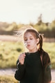 Portrait of brown haired little girl blowing on dandelion above defocused nature background. Portrait of brown haired little girl blowing on dandelion above defocused nature background. - PhotoDune Item for Sale