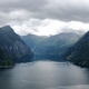 Magnificent Geirangerfjord in Norway. Fjord surrounded by majestic mountains, covered green trees Magnificent Geirangerfjord in Norway. Fjord surrounded by majestic mountains, covered green trees - PhotoDune Item for Sale