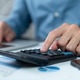 Businessman hands using a calculator to check company finances and earnings and budget. Businessman hands using a calculator to check company finances and earnings and budget. - PhotoDune Item for Sale