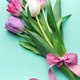 Tulips bouquet with pink ribbon on mint background Tulips bouquet with pink ribbon on mint background - PhotoDune Item for Sale