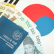 South Korean won money bills in big amount and passport lies on South Korea flag South Korean won money bills in big amount and passport lies on South Korea flag - PhotoDune Item for Sale