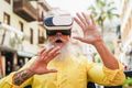 Senior hipster man using virtual reality headset outdoor - Metaverse concept - Focus on vr goggles Senior hipster man using virtual reality headset outdoor - Metaverse concept - Focus on vr goggles - PhotoDune Item for Sale