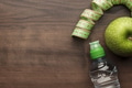 Bottle Of Water Measuring Tape And Fresh Green Apple Bottle Of Water Measuring Tape And Fresh Green Apple - PhotoDune Item for Sale