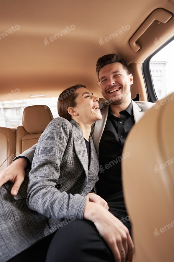 Happy couple in love cuddling in automobile Stock Photo by svitlanah