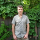 Man in plain shirt outdoor with greenery in background Man in plain shirt outdoor with greenery in background - PhotoDune Item for Sale
