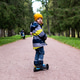 a little boy rides a scooter on a path in an autumn park a little boy rides a scooter on a path in an autumn park - PhotoDune Item for Sale