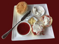 A serving of scones with strawberry jam and cream A serving of scones with strawberry jam and cream - PhotoDune Item for Sale