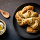 Zaatar puff pastry knots with labneh. Horizontal overhead view. Zaatar puff pastry knots with labneh. Horizontal overhead view. - PhotoDune Item for Sale