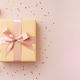 A pink giftbox with a pastel yellow bow on a pink. A pink giftbox with a pastel yellow bow on a pink. - PhotoDune Item for Sale