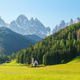 Scenic alpine landscape with church and majestic mountain peaks in verdant valley near Valley of Scenic alpine landscape with church and majestic mountain peaks in verdant valley near Valley of - PhotoDune Item for Sale