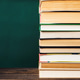 A stack of books on a table with a green background A stack of books on a table with a green background - PhotoDune Item for Sale