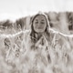 Young woman relaxing peacefully in rye field under bright sky Young woman relaxing peacefully in rye field under bright sky - PhotoDune Item for Sale