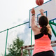 View from the back of a young woman who throws the ball into the basketball hoop, copy space. View from the back of a young woman who throws the ball into the basketball hoop, copy space. - PhotoDune Item for Sale