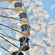 Part of Colorful Illuminated Ferris Wheel In Front Of Blue Cloudy Sky Part of Colorful Illuminated Ferris Wheel In Front Of Blue Cloudy Sky - PhotoDune Item for Sale
