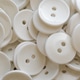 A lot of identical round white buttons A lot of identical round white buttons - PhotoDune Item for Sale