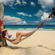 Woman in hammock on beach Woman in hammock on beach - PhotoDune Item for Sale
