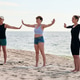 Adult women practicing group yoga on Baltic Sea beach during calm daylight Adult women practicing group yoga on Baltic Sea beach during calm daylight - PhotoDune Item for Sale