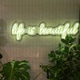 “Life is beautiful” green neon sign surrounded by plants “Life is beautiful” green neon sign surrounded by plants - PhotoDune Item for Sale