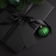 Black Christmas Gift Box with Satin Ribbon and Green Ornaments on Dark Holiday Background Black Christmas Gift Box with Satin Ribbon and Green Ornaments on Dark Holiday Background - PhotoDune Item for Sale