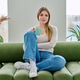 Portrait of relaxed beautiful young woman sitting at home on sofa with cup Portrait of relaxed beautiful young woman sitting at home on sofa with cup - PhotoDune Item for Sale