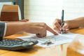 Buyers are signing a home purchase agreement from a broker. Buyers are signing a home purchase agreement from a broker. - PhotoDune Item for Sale