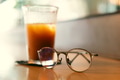 Ice brew coffee with reading glasses on the table Ice brew coffee with reading glasses on the table - PhotoDune Item for Sale