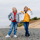 Two schoolmates relax and have fun on stone embankment. Two schoolmates relax and have fun on stone embankment. - PhotoDune Item for Sale