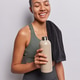 Vertical shot of Latin woman feels satisfied keep eyes closed dressed in activewear poses with towel Vertical shot of Latin woman feels satisfied keep eyes closed dressed in activewear poses with towel - PhotoDune Item for Sale