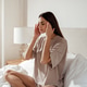 Young woman in bed practicing relaxation and self-care routine, massaging temples to cure headache Young woman in bed practicing relaxation and self-care routine, massaging temples to cure headache - PhotoDune Item for Sale