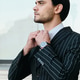 Young handsome serious stylish man classic striped jacket thoughtfully looking aside outdoors Young handsome serious stylish man classic striped jacket thoughtfully looking aside outdoors - PhotoDune Item for Sale