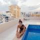 A relaxing yoga session by the pool in an urban setting offers a blissful retreat A relaxing yoga session by the pool in an urban setting offers a blissful retreat - PhotoDune Item for Sale